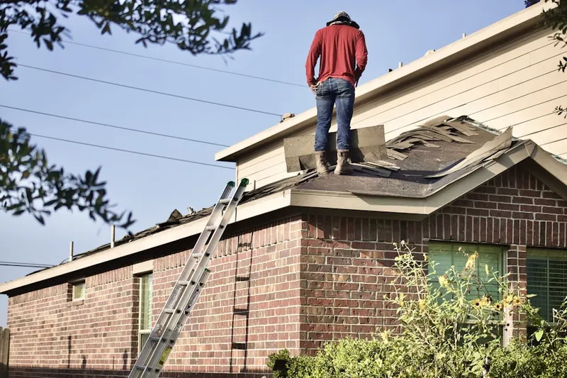 Professional roofer working on a residential roof in Goulder